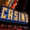 A yellow casino sign with blue lights